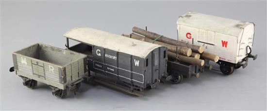 A bolster wagon with logs, in black, a Midland Region open wagon in grey, a Great Western box wagon, no. 17104,